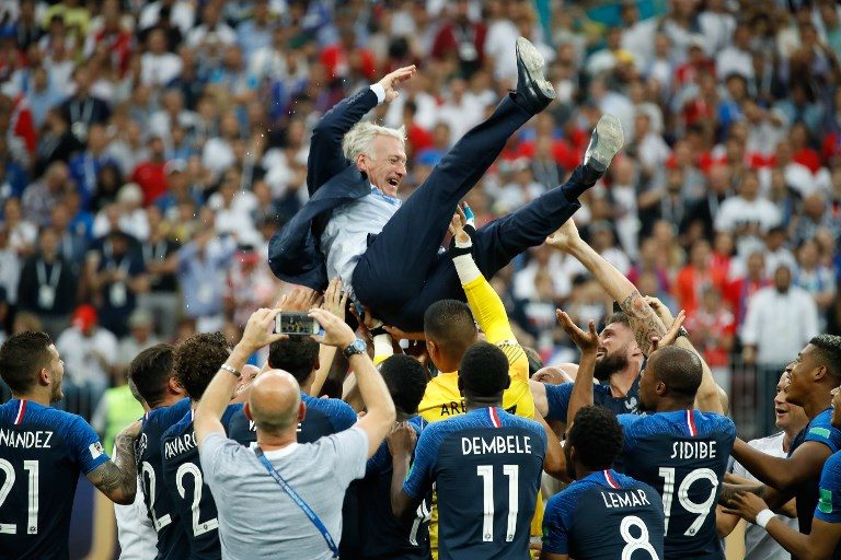 VICTORY RIDE. France's coach Didier Deschamps is thrown in the air after the final whistle. Photo by Odd Andersen/AFP  