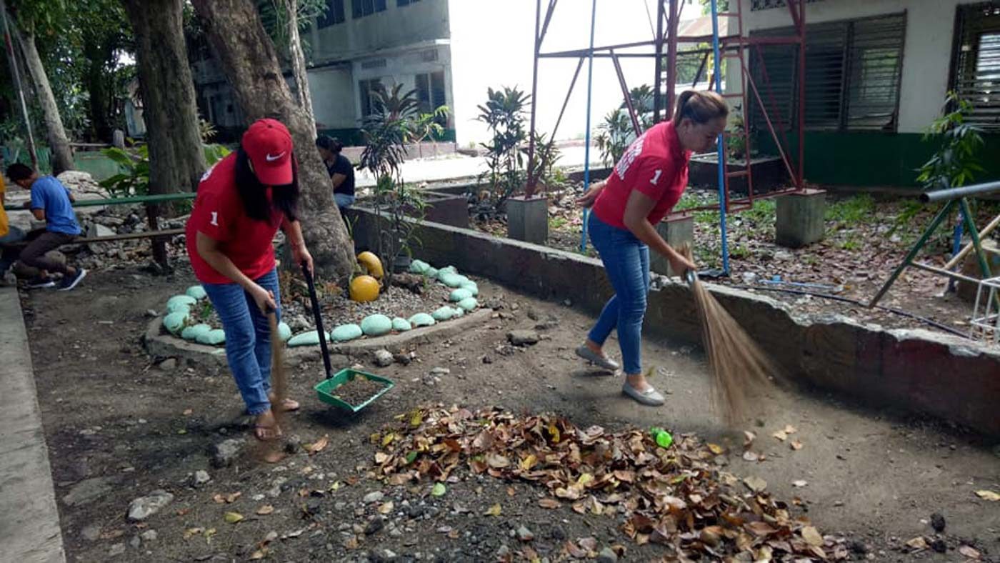 BACOLOD CITY. Volunteers sweep dried leaves at the Bacolod City National High School. Photo from Vice Mayor Ed Familiaran's Facebook page  