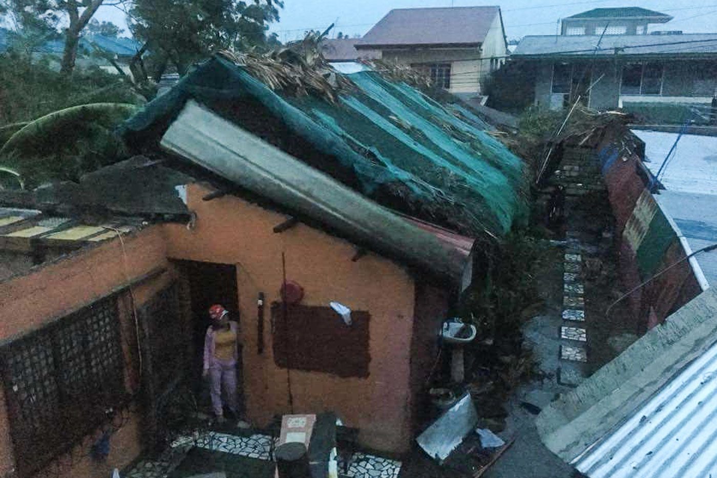 BLOWN OFF. Strong winds rip roofs off houses in Laoag City, Ilocos Norte. Photo by MJ Valiente Valdez   