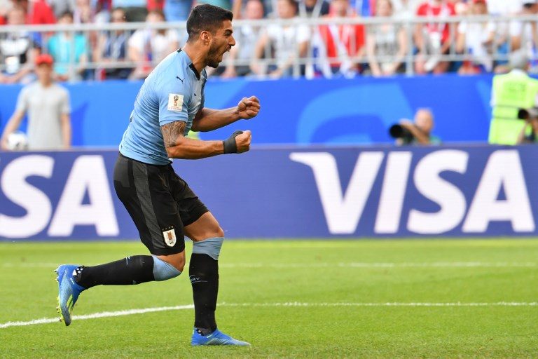 Uruguay tops group as Suarez inspires win over 10-man Russia