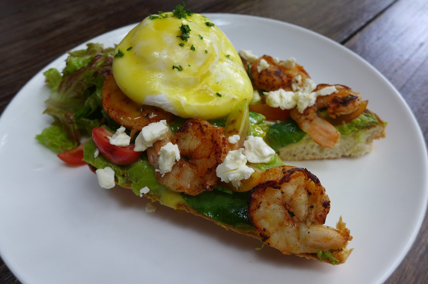 HEALTHY OPTION. Grilled shrimps with smashed avocado, cherry tomato, feta cheese and poached egg.
 