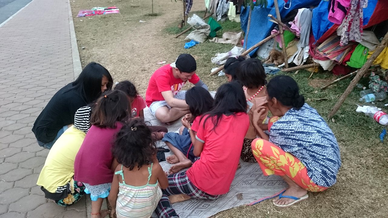 BONDING. Lumad children sit on a mat and bond outside their temporary shelter. 