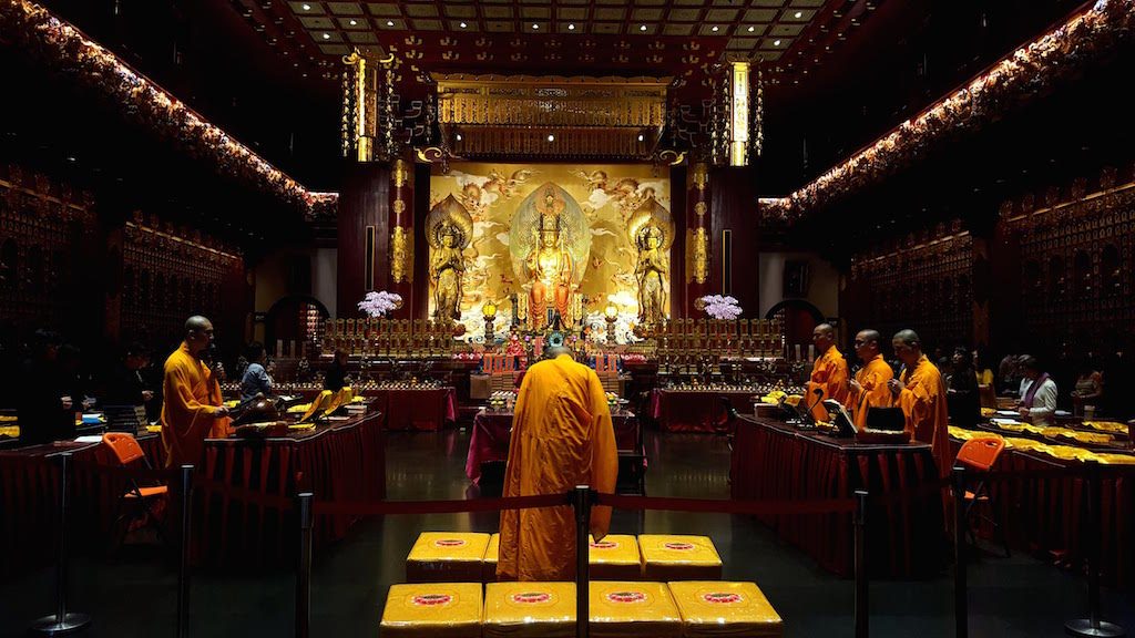 PLACE OF WORSHIP. Buddhist monks pray at the Buddha Tooth Relic Temple.  