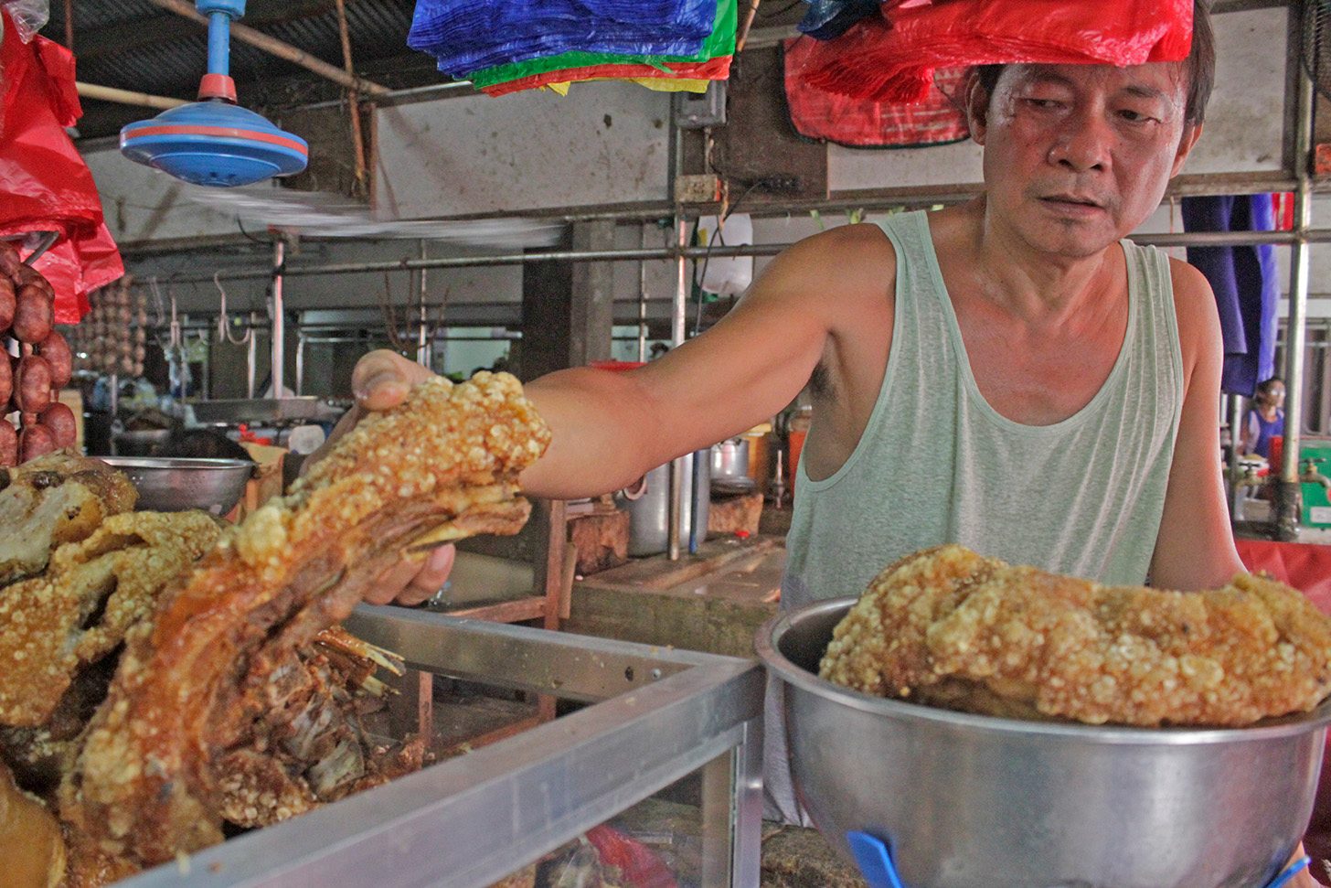 READY TO BE SOLD. Mang Mauro prepares the bagnet to be sold for the day.     