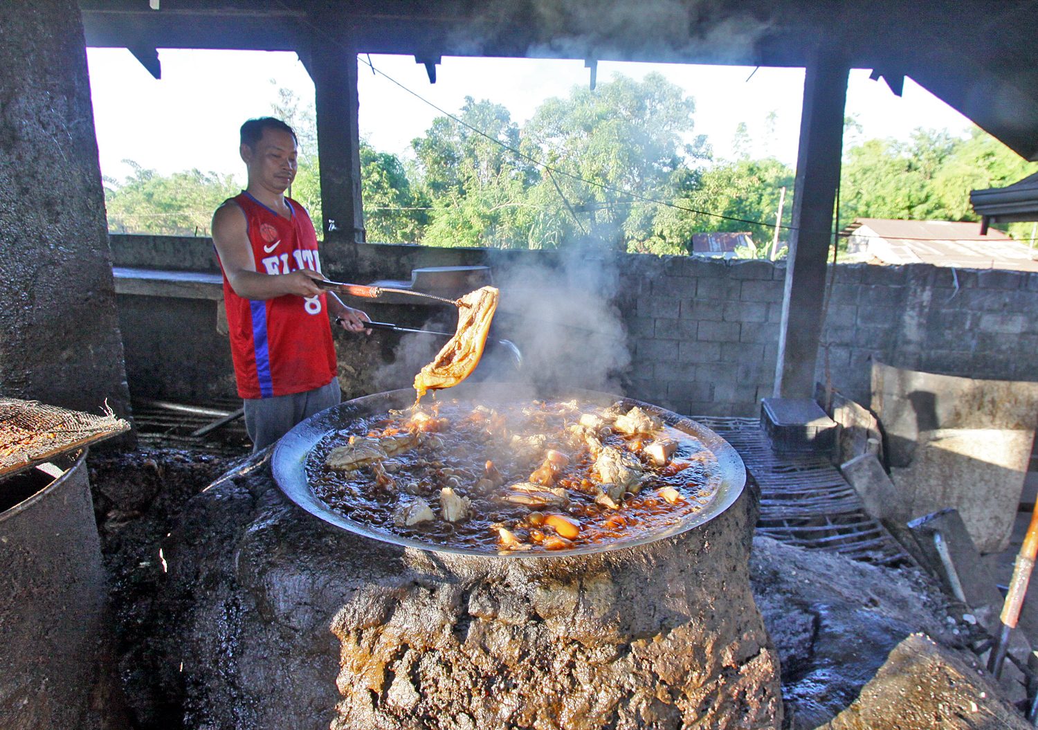 TRADITIONAL WAY. Backyard workers are up 1 am daily to prepare bagnet, which cooks for 3 straight hours in the kawa using firewood. Bagnet chunks  are ready by 6 am in the public market for early travelers who buy in bulk.   