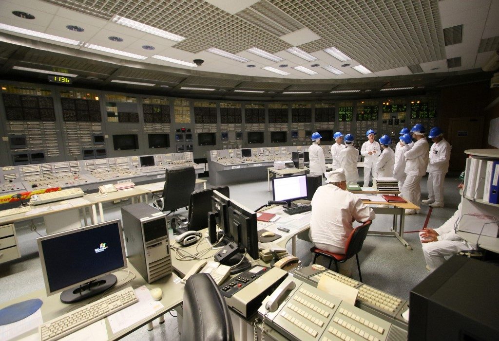 FEELING. People stand in the monitoring room during a guided tour inside the inoperative Ignalina nuclear power plant in Visaginas, Lithuania, on July 31, 2019. Photo by Petras Malukas / AFP 