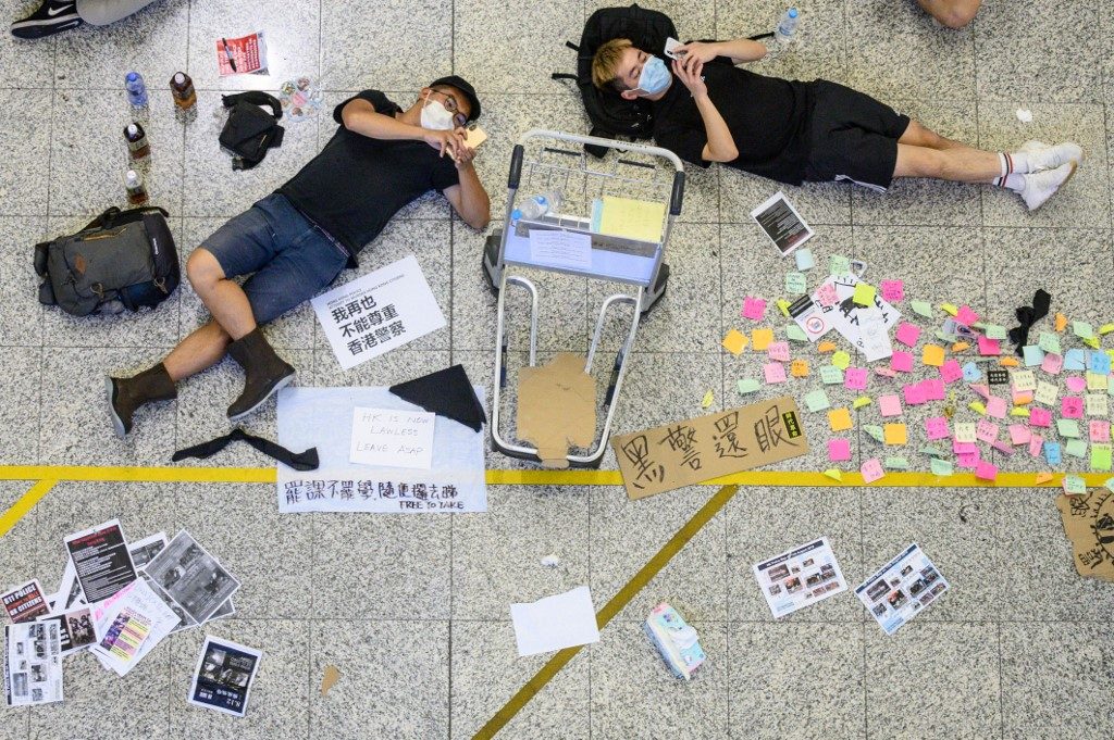 REST. Protesters rest at Hong Kong's International airport during a protest against the police brutality and the controversial extradition bill on August 12, 2019. Photo by Philip Fong/AFP 
