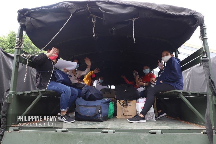 OFF TO THE AIRPORT. Stranded travelers board Army trucks that will bring them to the airport for their flights home on June 19, 2020. Photo from the Philippine Army
 