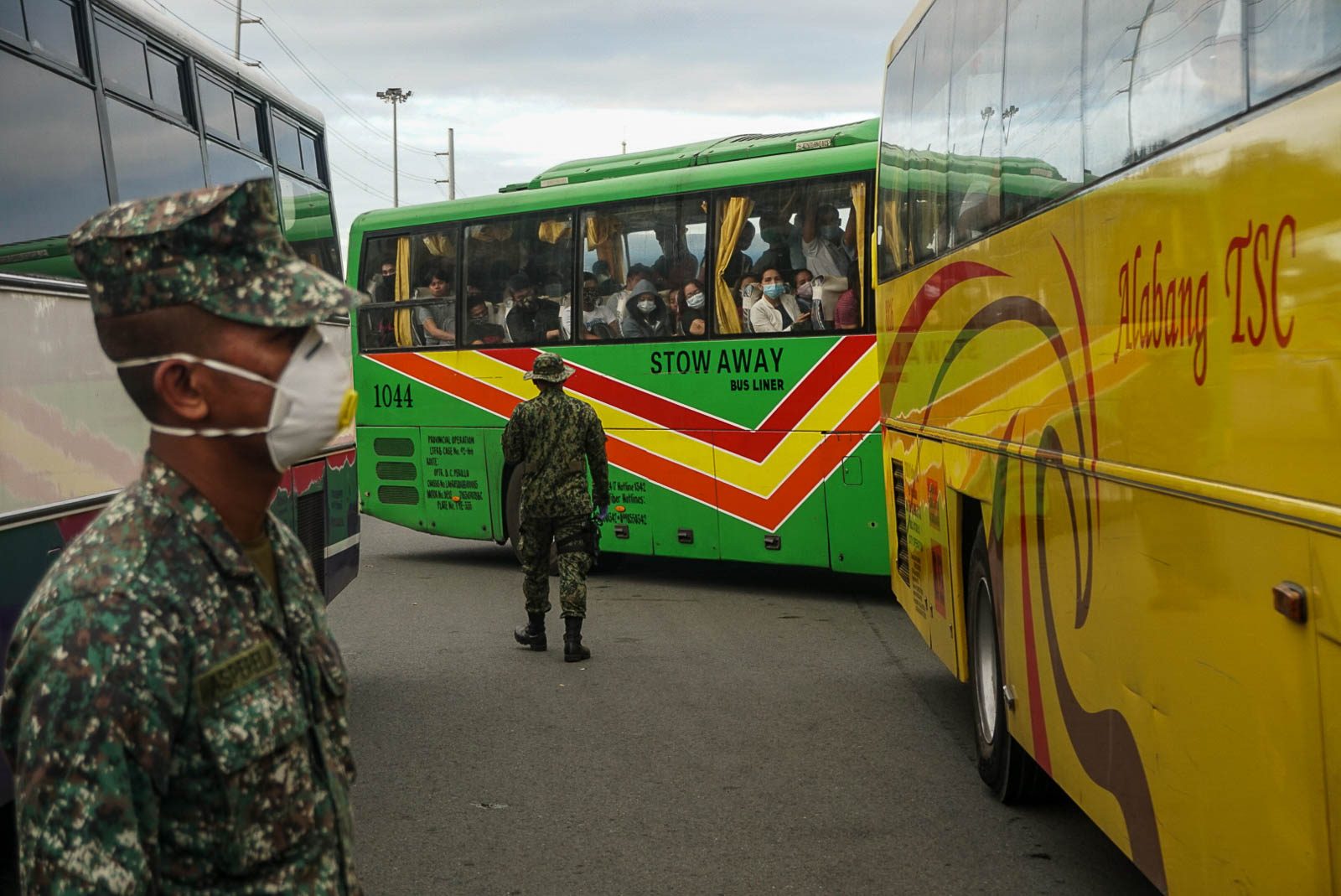 ON GUARD. Police officers stand guard as bus passengers get their temperatures checked at the Cavitex exit in Paranaque City on March 16, 2020. Photo by Dante Diosina Jr. 