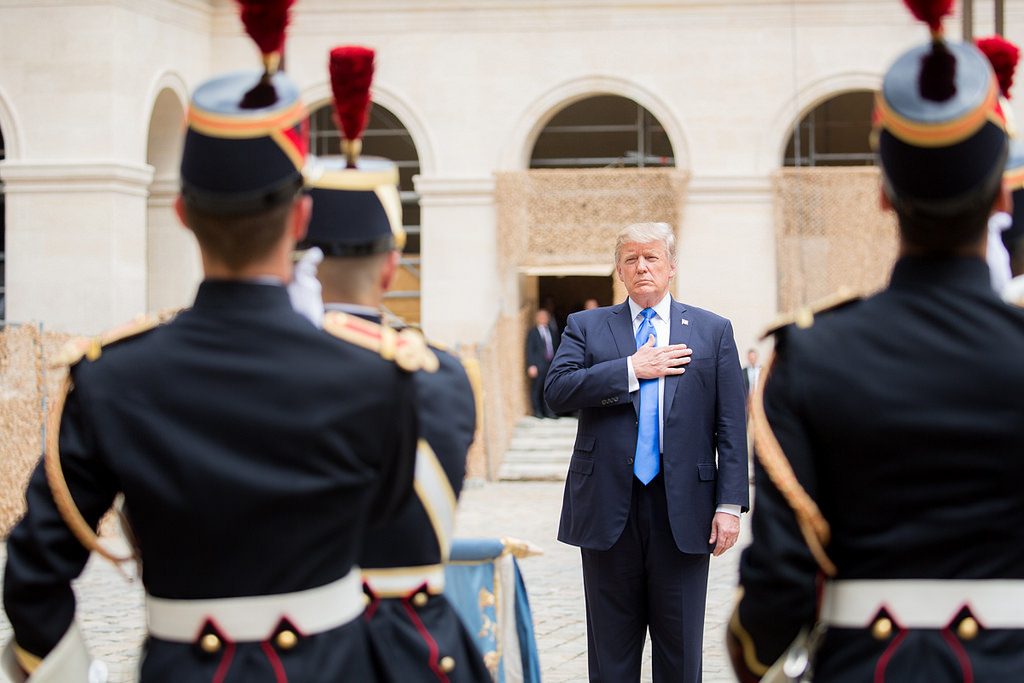 Trump back on offensive after brief respite in Paris