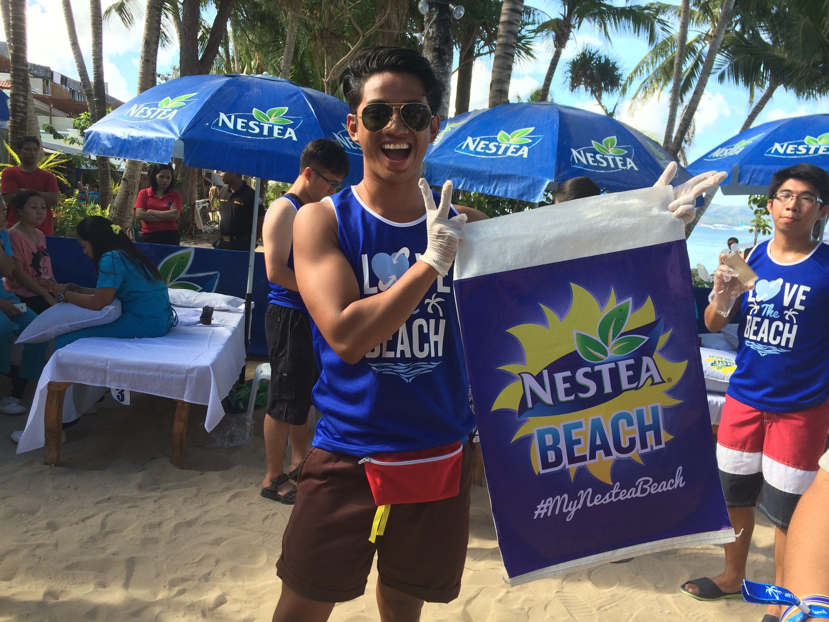 DO YOUR PART! David Guison volunteers for the Nestea Beach clean-up. 