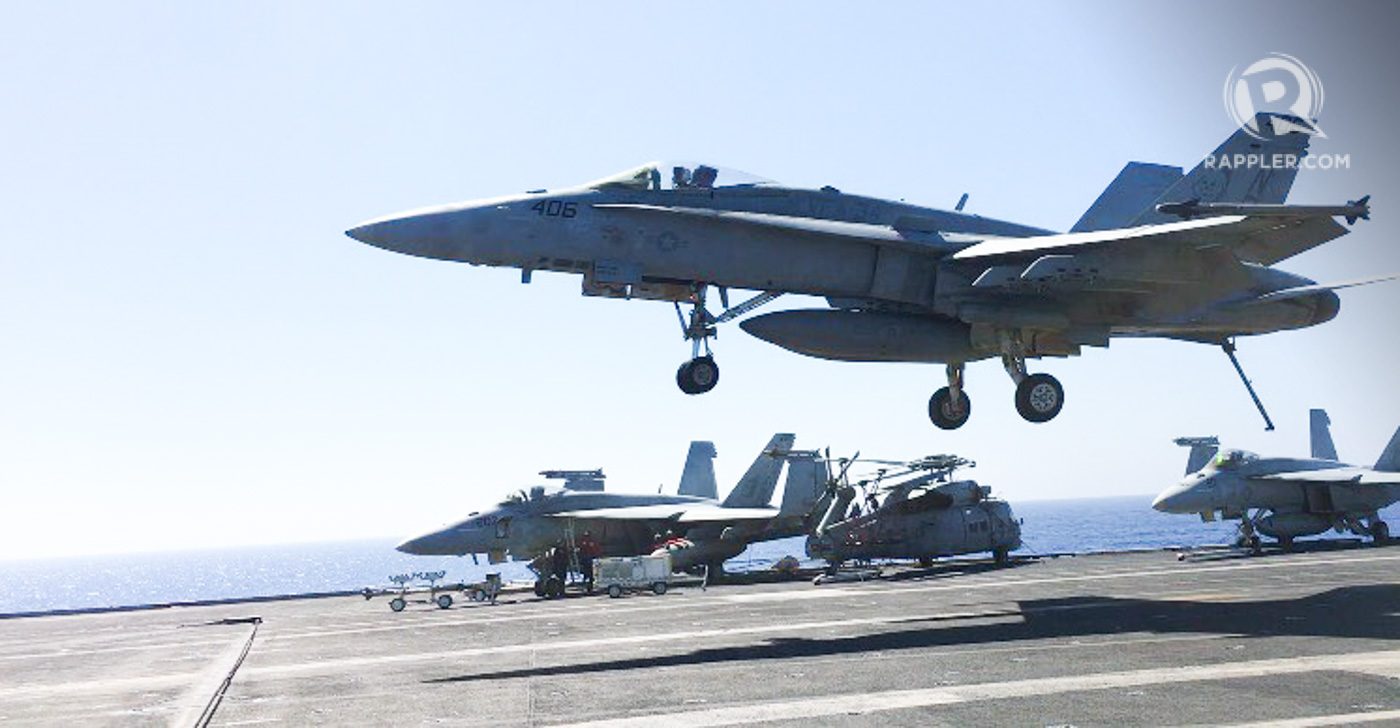 HORNET. An F-18 Hornet about to land on the flight deck of the USS Carl Vinson. Since the runway is short, the aircraft must hook (rear pointing downwards) onto arresting cables on the deck to bring it to a complete stop. Photo by Camille Elemia/Rappler    