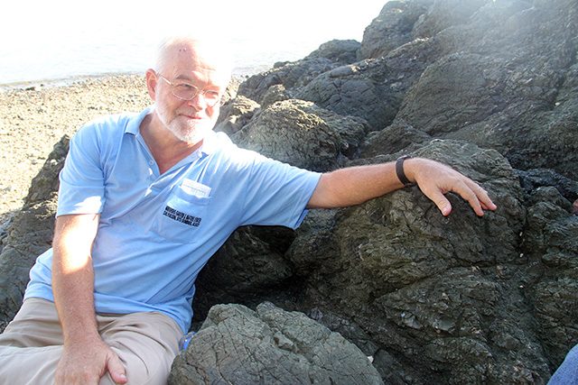 VOLCANO EXPERT. World renowned geologist Christopher Newhall, sitting on a pillow lava formation. Photo by Rhaydz Barcia  