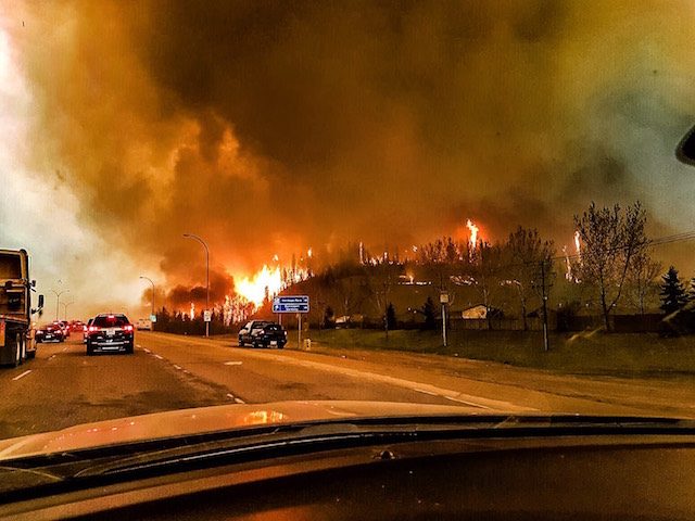 Canadians drive through burning city seeking safety