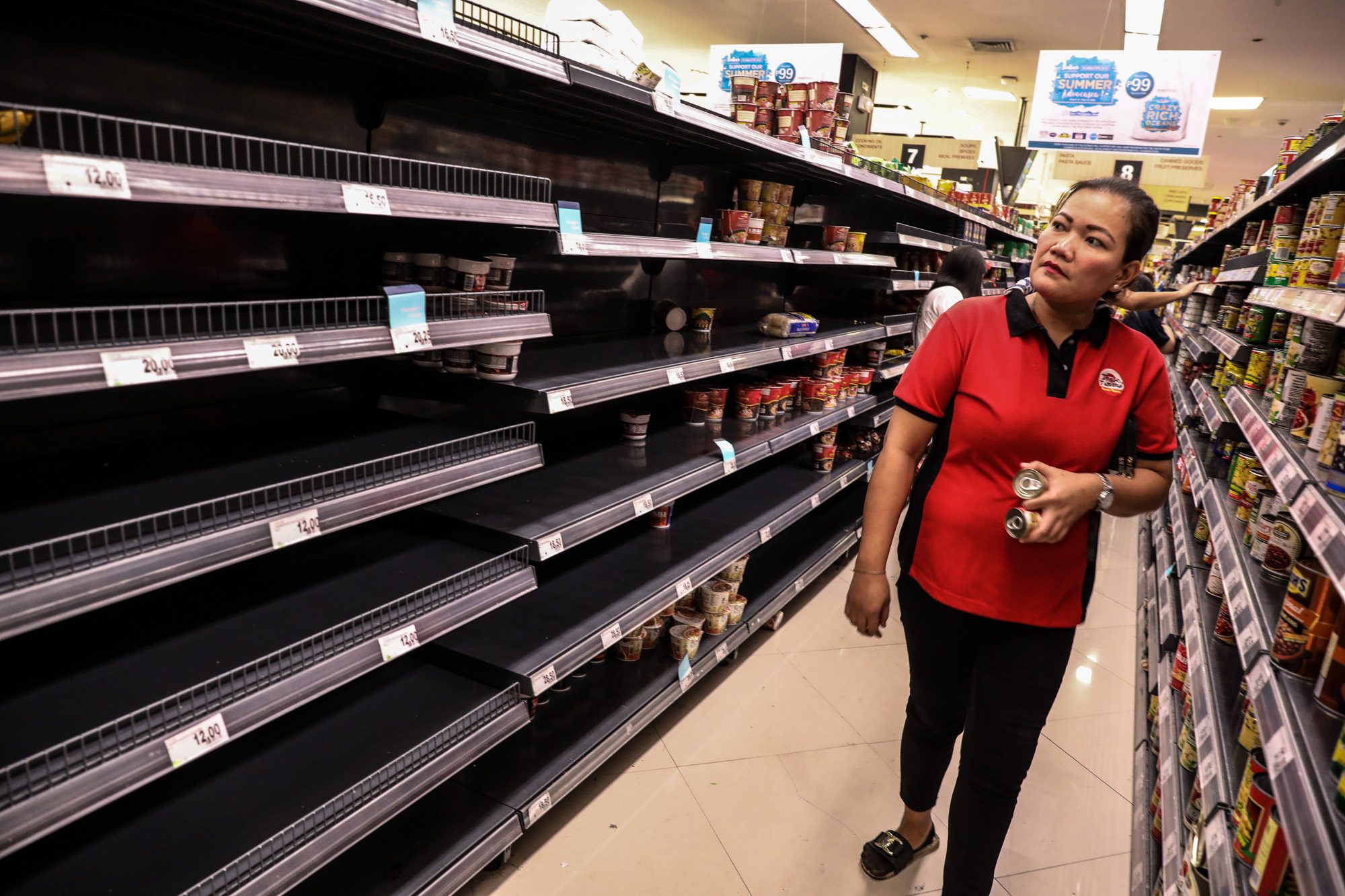 EMPTY SHELVES. The rush to stock up on food and supplies during the lockdown to avert the coronavirus has left store shelves empty, like this one in Taguig City. Photo by Jire Carreon/Rappler 