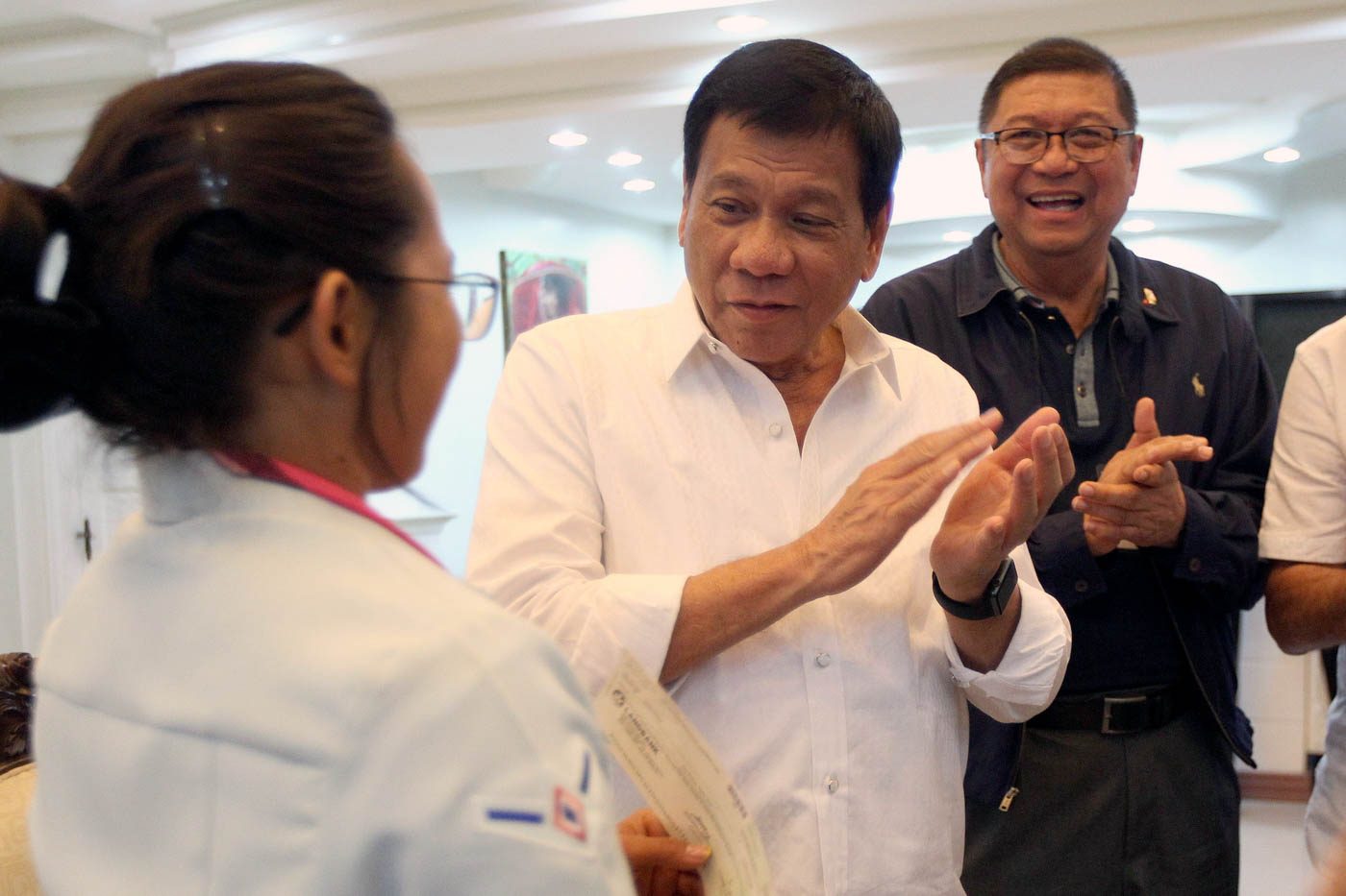 President Rodrigo Duterte and Philippine Sports Commission Chairperson William Ramirez applaud Hidilyn Diaz, the first Filipina and Mindanaoan Olympic silver medalist, during a courtesy call at the Presidential Guest House in Panacan, Davao City on August 11. Photo by Ace Morandante/PPD  
