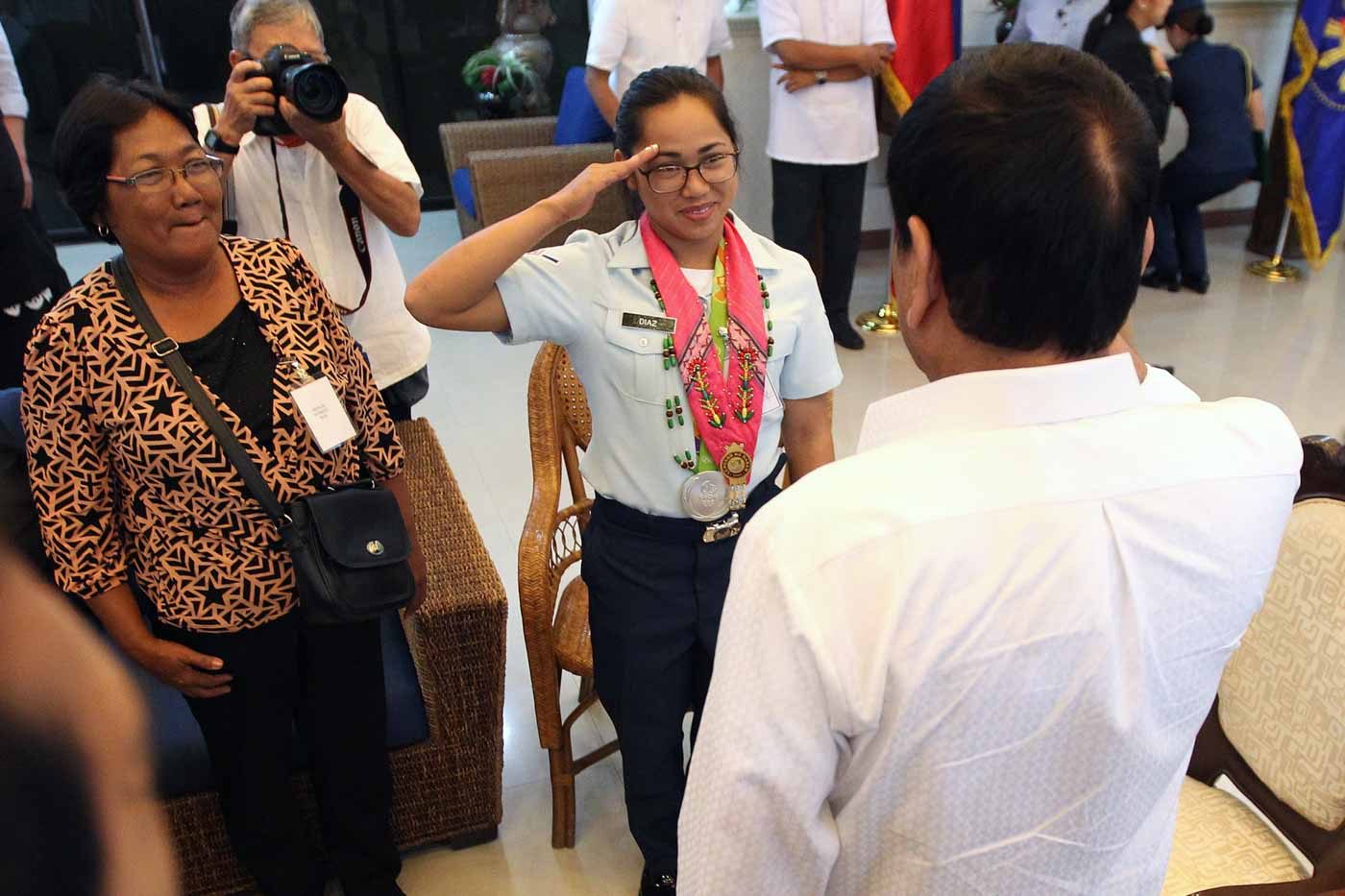 President Rodrigo Duterte gives Airwoman Second Class Hidilyn Diaz a congratulatory salute during a courtesy call at the Presidential Guest House in Davao City on August 11. Diaz, who won a silver in Rio, is the first Filipina and Mindanaoan Olympic medalist. Photo by Ace Morandante/PPD  