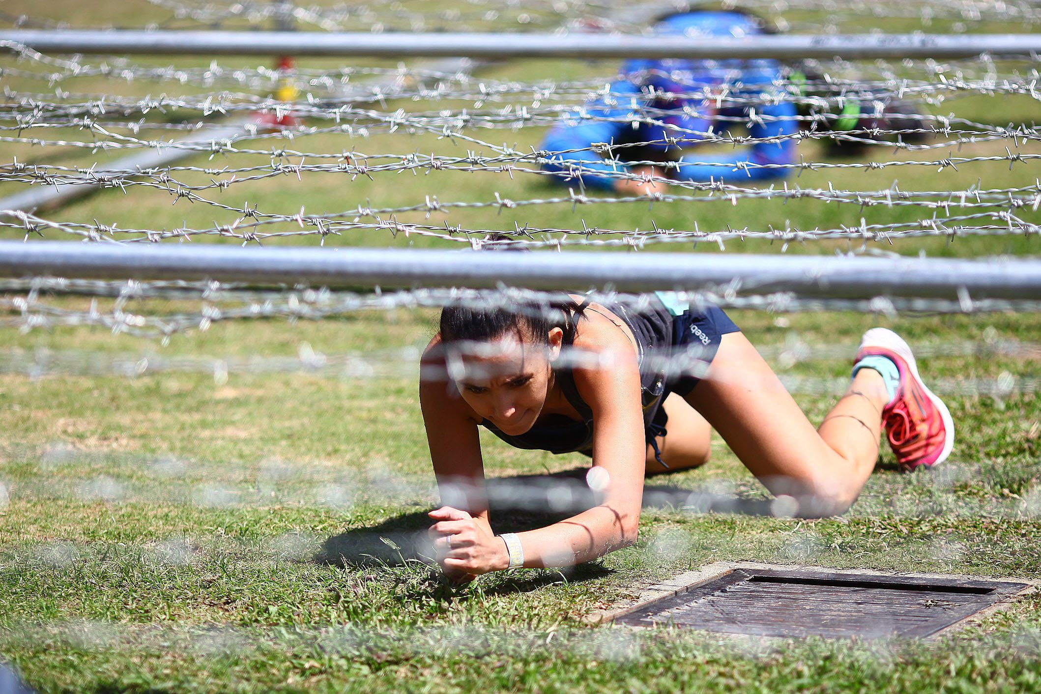 GRUELING COMPETITION. A contestant crawls under barbed wire. Photo by Josh Albelda/Rappler   