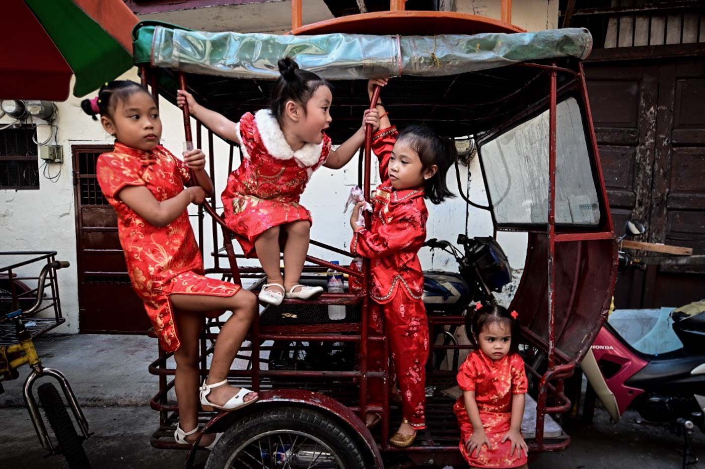 'CHINOYS'. Filipino children in cheongsams play along an alley in Binondo, Manila during the celebration of the Chinese lunar new year on February 5, 2019. Photo by Alecs Ongcal/Rappler    