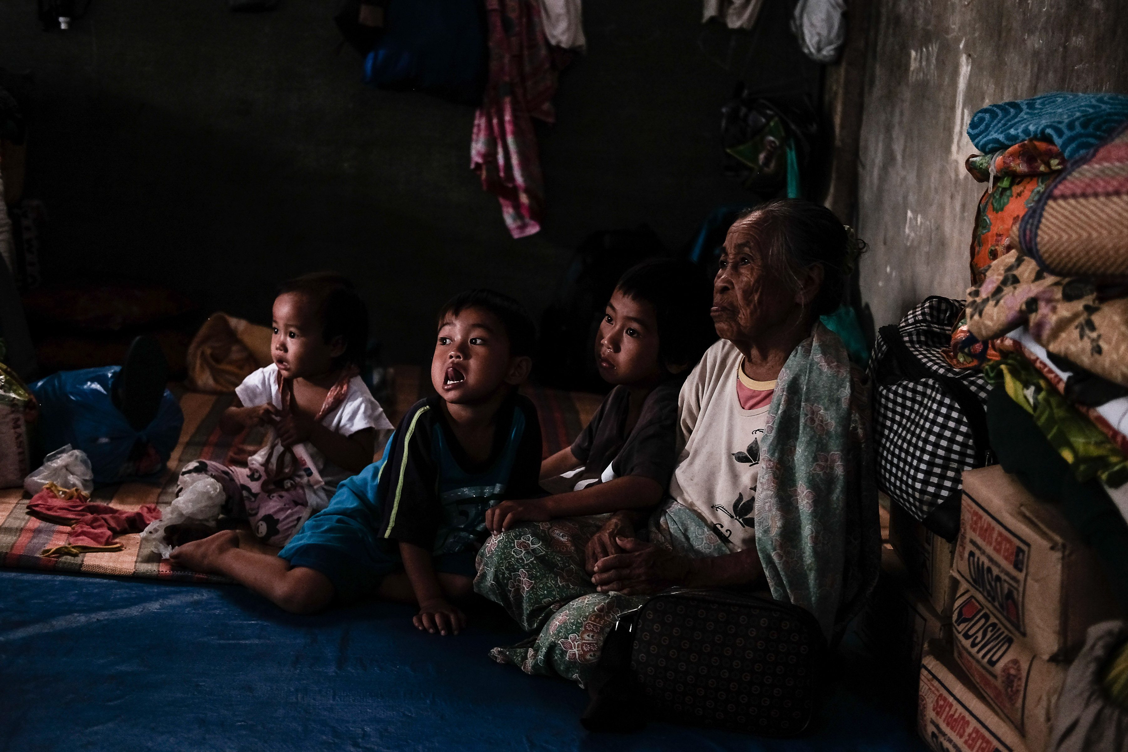 RECOVERY. An elderly Maranao woman is flanked by her grandchildren in Al-Qayriya Madrasa, an evacuation center in Balo-i, Lanao del Norte. Photo by Bobby Lagsa/Rappler 
