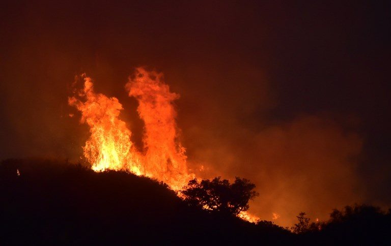 Returning winds churn up heightened alert in fire-hit California