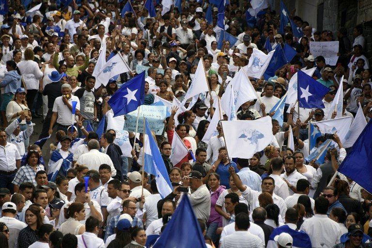 Marches back Honduras president in drawn-out, contested election