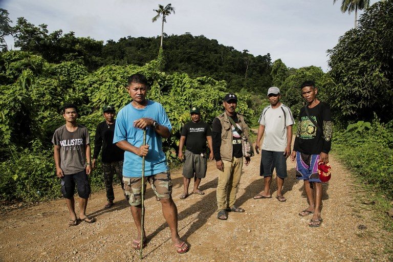 ENVIRONMENTAL CRUSADE. This photo taken on September 26, 2017, shows Efren 'Tata' Balladares (3rd-L), one of the leaders of the Palawan NGO Network Inc (PNNI), standing in front of other para-enforcers from the group on the outskirts of a forest near the tourist town of El Nido, on Palawan island in the Philippines. Karl Malakunas/AFP 