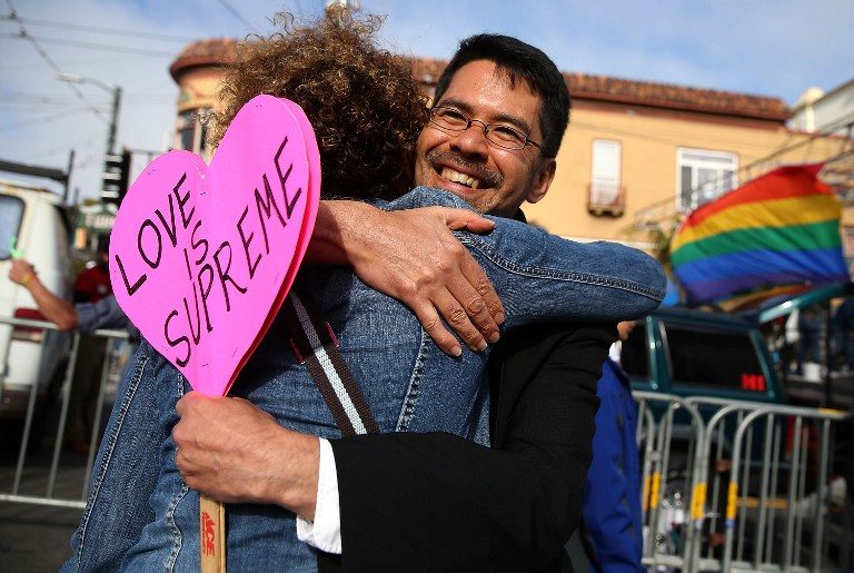 EQUALITY. Same-sex marriage supporter Stuart Gaffney hugs a friend while celebrating the USSupreme Court. Photo by Justin Sullivan/Getty Images/AFP  
