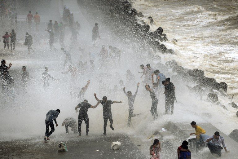 MOONSOON. People gather by the Marine Drive seafront, waiting to be hit by breaking waves at high tide in Mumbai, India, on June 28, 2017. Photo by Punit Paranjpe/AFP   