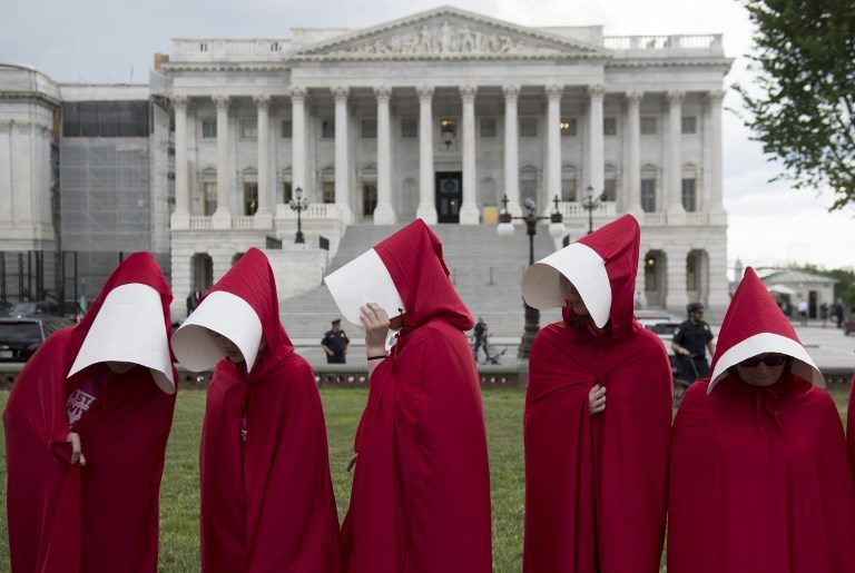 US HEALTHCARE PROTEST. Supporters of Planned Parenthood dressed as characters from 'The Handmaid's Tale' hold a rally as they protest the US Senate Republicans' healthcare bill outside the US Capitol in Washington DC on June 27, 2017. Photo by Saul Loeb/AFP   
