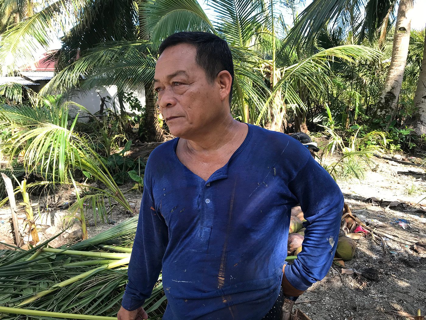After Typhoon Ursula struck, Pedro Gagap, 65, spends his time repairing his neighbors' fishing boat. He said he couldn't go back to fishing just yet, so in the meantime, doing repairs would be a big help to meet their daily needs. Photo by Jene-Anne Pangue/Rappler    