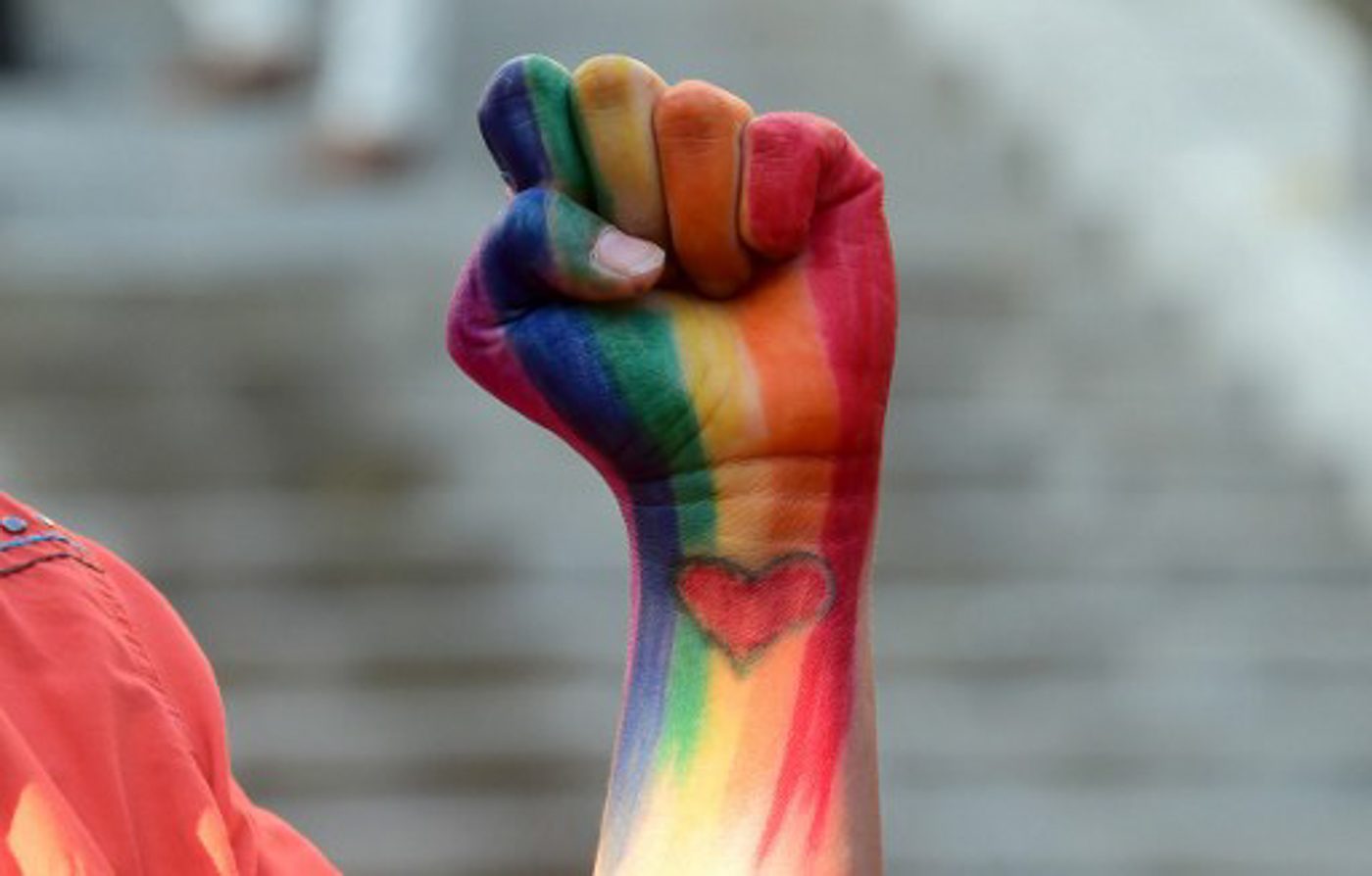 Dominique Hernandez displays her rainbow-colored fist, with heart painted on pulse in honor of those slain in the Orlando shootings during a vigil for the shootings in Orlando at Los Angeles City Hall on June 13, 2016 in Los Angeles, California. Frederic Brown/AFP 