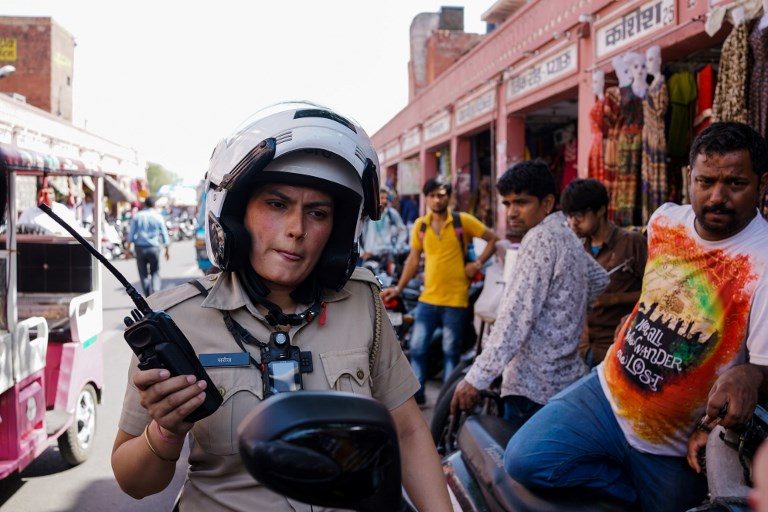 ON PATROL. In this photo taken on June 14, 2017, Saroj Chodhuary, an Indian police constable and a member of a newly launched female police patrol unit, listens to her radio at the old market in Jaipur. Chandan Khanna/AFP 