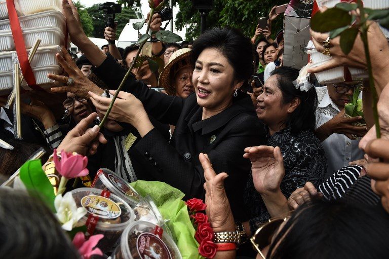 Roses, tears as Thai ex-PM Yingluck enters final stage of case