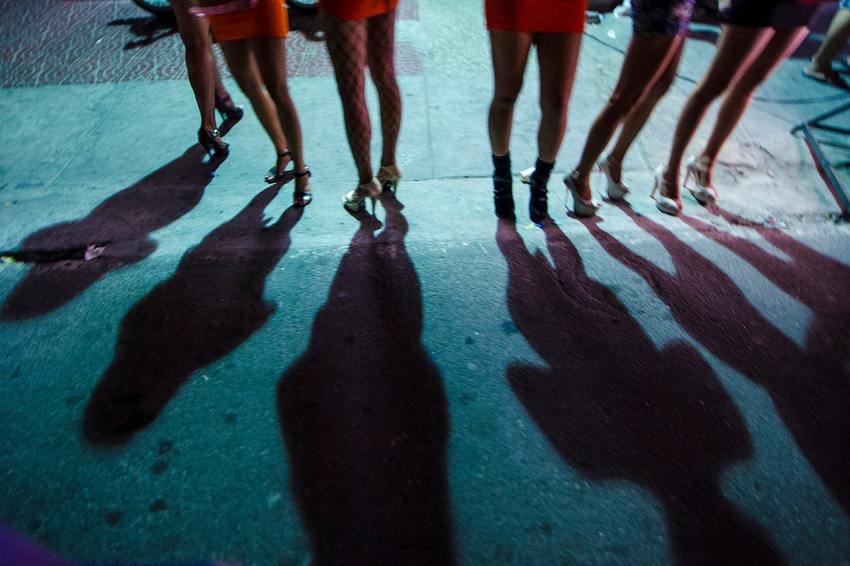 Behind the spotlight, women line up in front of a KTV bar in Malate. Photo by Rob Reyes/Tokwa Collective for Rappler  