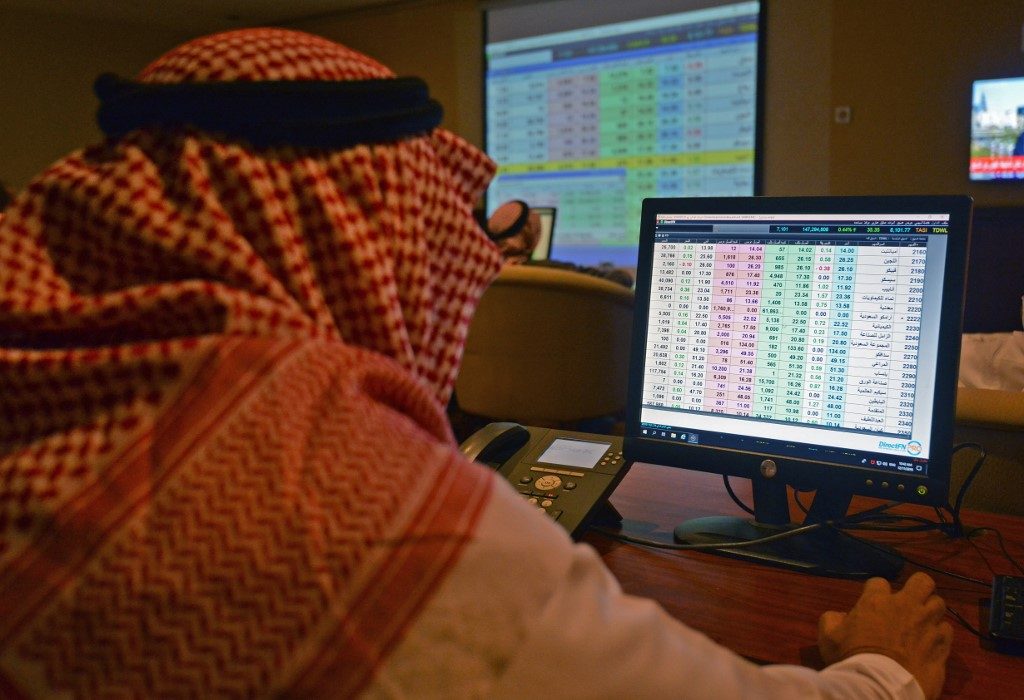 Saudi Aramco shares shed post-IPO gains as oil dives