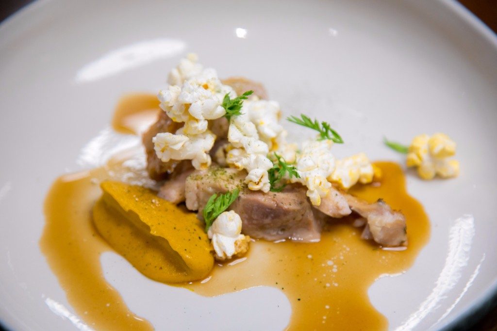 'COOP.' The dish – chicken served with a carrot puree and topped off with popcorn – is an interesting mix of textures and flavors. Photo by Paulo Buendia 