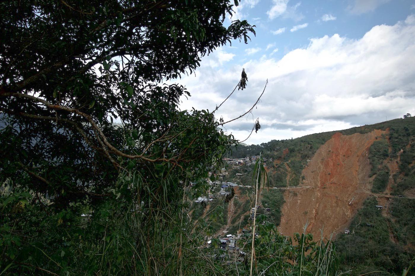 LANDMARK. The collapsed soil turns an entire section of the Itogon mountainside bare. Photo by Rambo Talabong/Rappler  