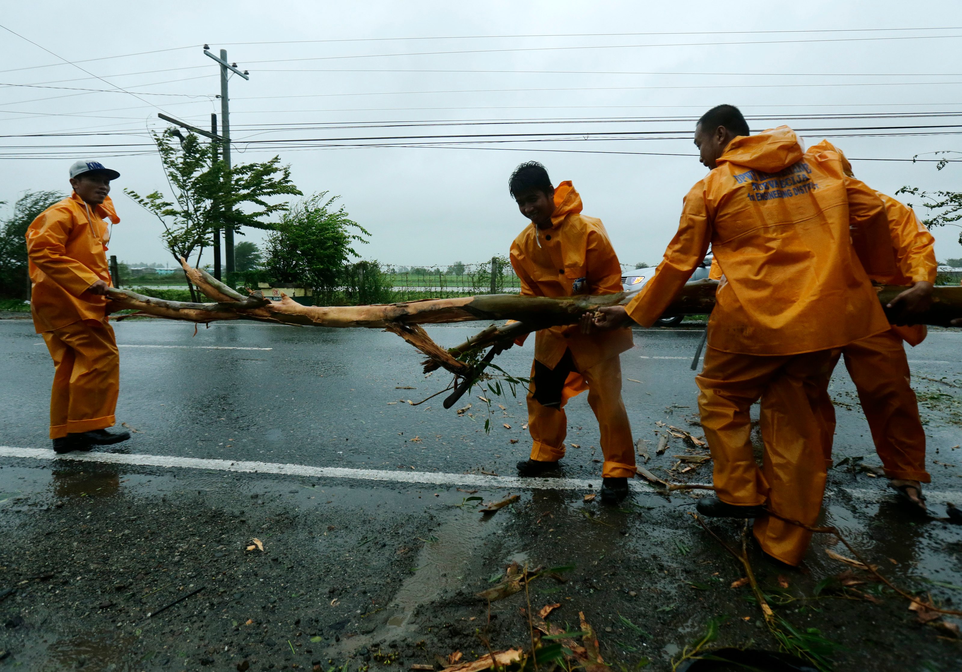Government workers remove debries at a highway in Cabanatuan City, Nueva Ecija on October 18, 2015 after Typhoon Lando (Koppu) slammed into the northern Philippines. Photo by Francis Malasig/EPA 