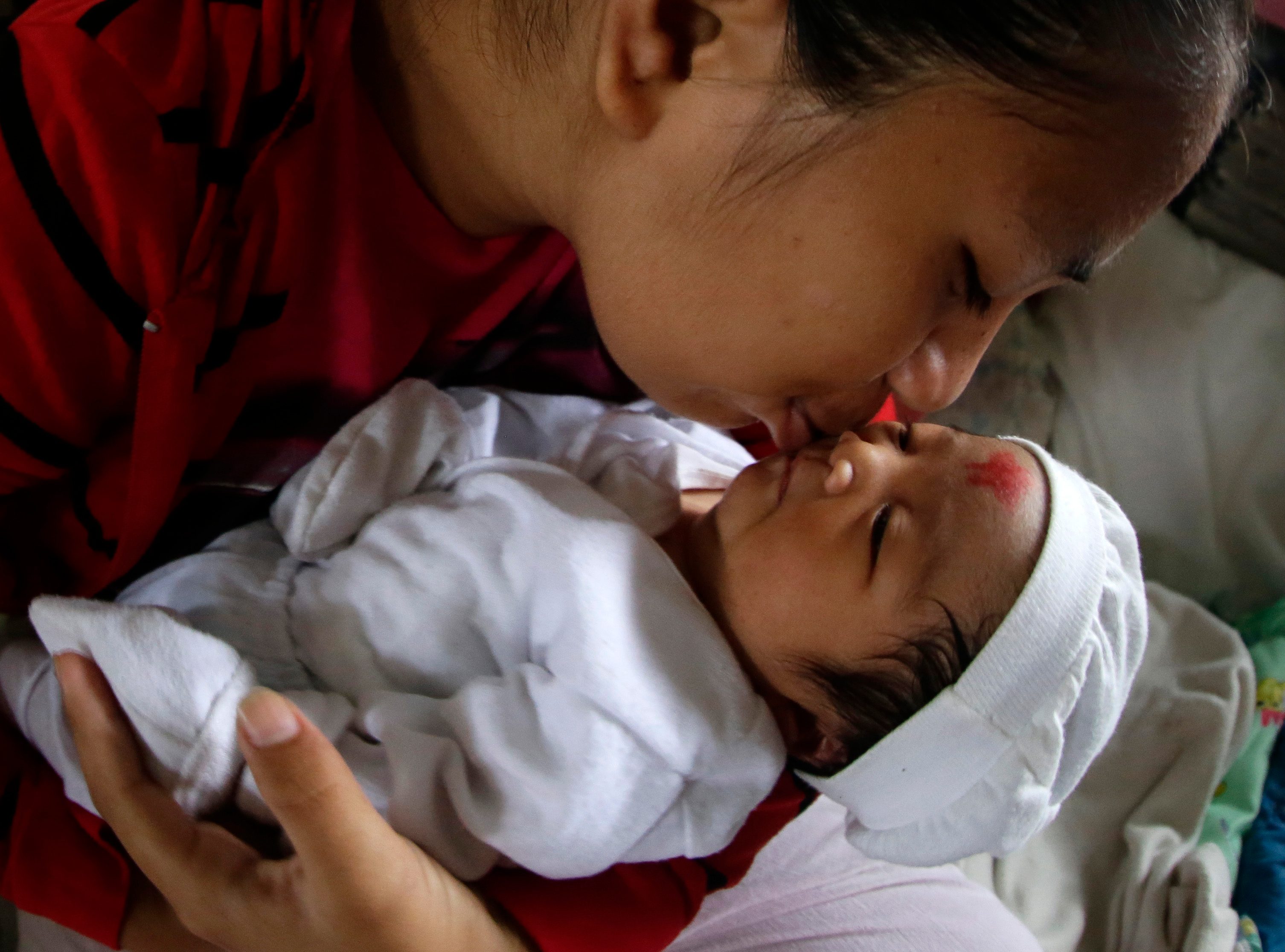 HELP THEM. Rosalie Santos kisses her newly born baby, Samantha, at a school turned into an evacuation center in San Jose city, Nueva Ecija province, northern Manila, Philippines, 18 October 2015. Photo by Francis Malasig/EPA 