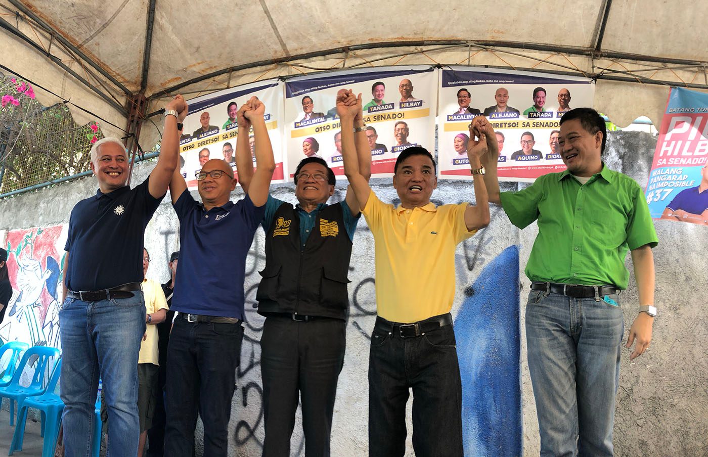 A RARE SCENE. Muntinlupa City Mayor Jaime Fresnedi (2nd from R) raises the hands of Otso Diretso candidates in a campaign event on March 5, 2019. Photo by Mara Cepeda/Rappler    