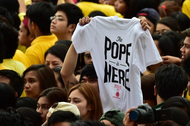 A student holds a T-shirt during the visit by Pope Francis to the University of Santo Tomas in Manila on January 18, 2015. Photo by Giuseppe Cacace/AFP