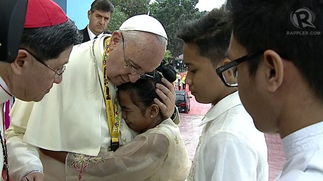 12-year-old street kid Glyzelle Palomar gets a warm hug from the Pope.