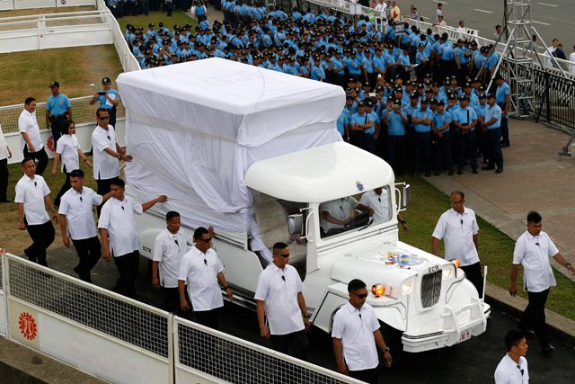 Security officers walk along a special 'Jeepney,' in which Pope Francis is expected to ride, during a dress rehearsal simulation at an open field of the Luneta park in Manila, 14 January 2015. Photo by Francis Malasig/EPA