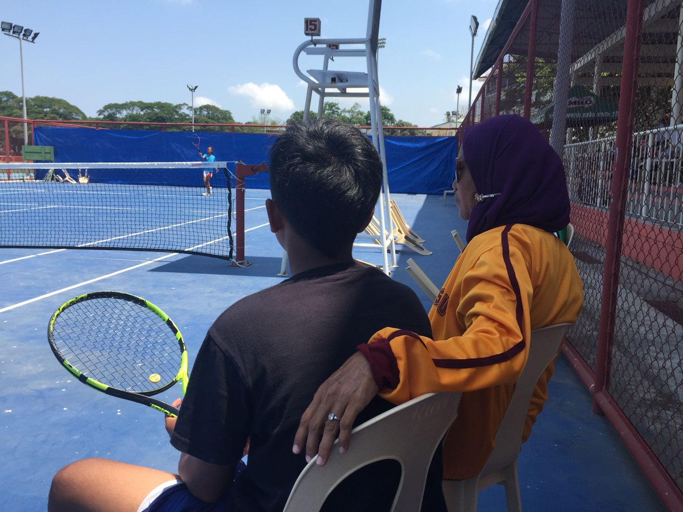 ADVICE FROM COACH. Sinagmaga places her hand on Prince's back as he rests during practice. 