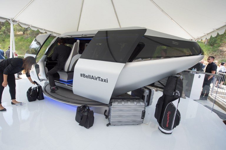 BELL AIRTAXI. An attendee gets into a full sized model of Bell's unnamed air taxi cabin concept. Photo by Robyn Beck/AFP 