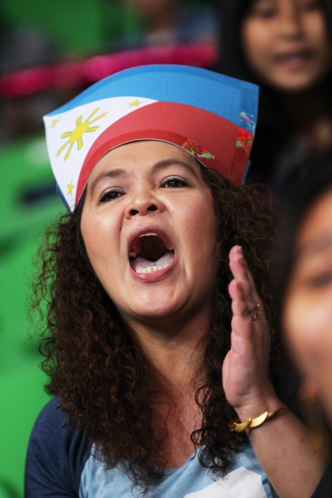 PILIPINAS. A fan proudly wears the Philippine flag over her head as she cheers for Gilas. Photo from FIBA 