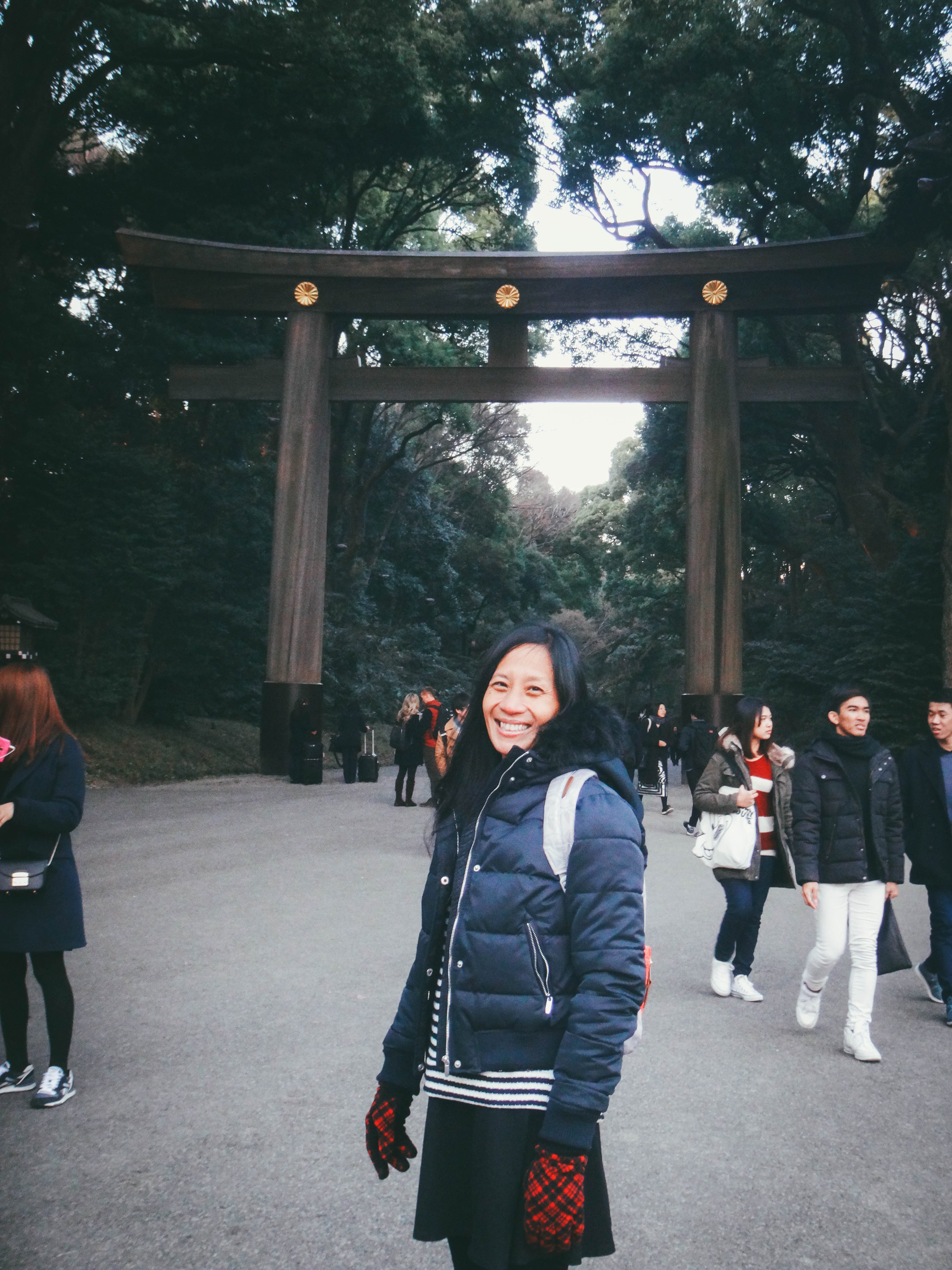 MEIJI SHRINE. The author's mother poses in front of the Meiji Shrine's torii gate, a fixture found in Shinto shrines. Photo provided by Irene Maligat  