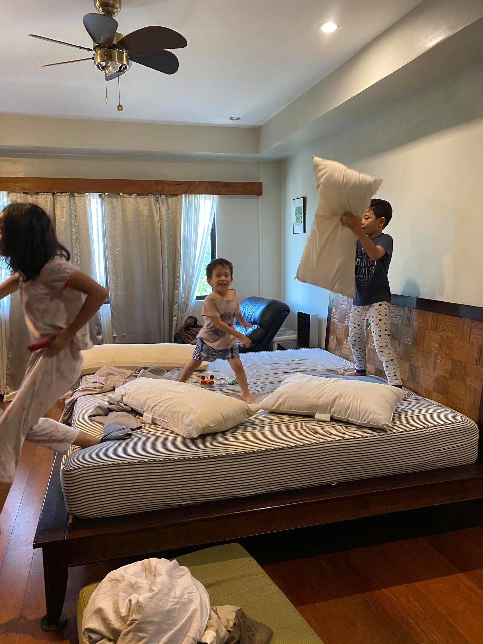 PRODUCTIVE PLAY. The kids enjoy a pillow fight – a privilege that comes with changing bedsheets. Photo courtesy of Nikki Briones Carsi-Cruz 