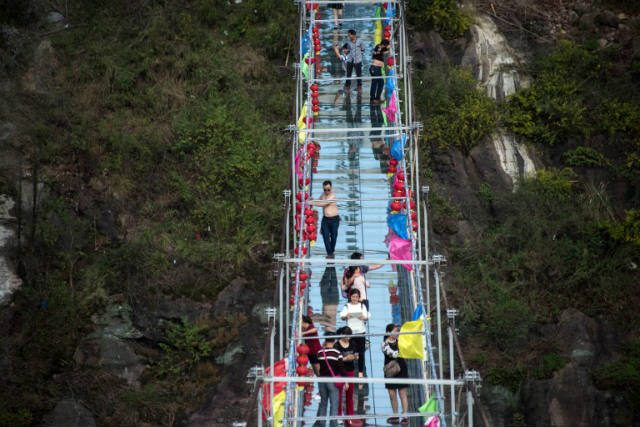 IN PHOTOS: China’s new glass bridge tests courage of tourists